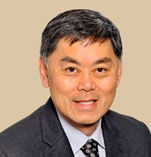 Benjamin Chu has short black hair and is wearing a suit.