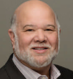 Alonzo Plough is mostly bald with white facial hair.