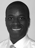 Jean Raphael is a bald man wearing a white shirt and tie.