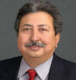 Fernando Sanchez Mendoza has short gray hair and a moustache. He is wearing a suit.