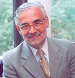 Marcelo Suárez-Orozco has short gray hair and glasses. He is wearing a gray blazer.