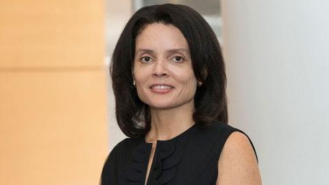 Michelle Johnson has shoulder-length straight black hair. She is wearing a black dress.