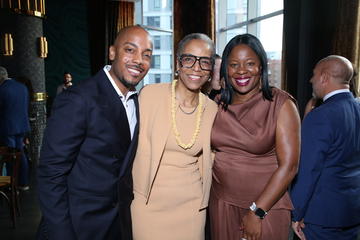 Two alumni fellows pose with Joan Reede.