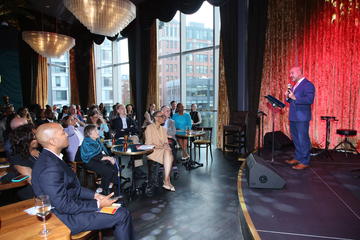 Joe Betancourt speaks to a seated audience at Grace By Nia.