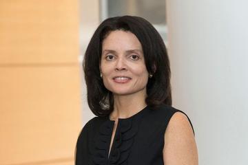 Michelle Johnson has shoulder-length straight black hair. She is wearing a black dress.