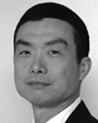 Anthony Chen has cropped black hair and is wearing a suit.