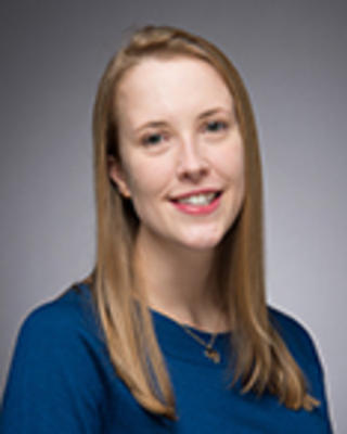Chloe Slocum has long straight blonde hair. She is wearing a blue shirt.