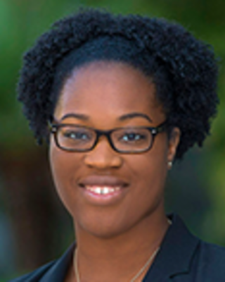 Nnenna Ezah has short coily black hair and glasses.