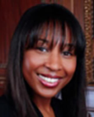 Kim Narain has long straight black hair with bangs.