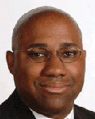 Mallory Williams is a bald man with glasses.