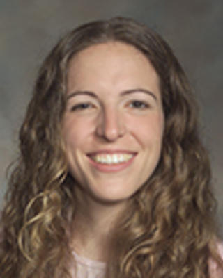 Samantha Rosman has long curly blong hair.