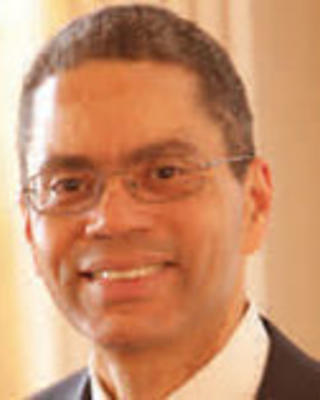 Bruce Seigel has short gray hair and glasses.