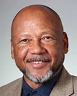 Brian Swann is a bald man with a goatee and moustache.