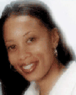 Stephanie Hale has long straight black hair. She is wearing a white shirt.