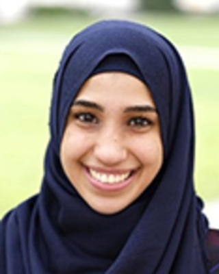 Nora Abo-Sido is standing outside. She is wearing a dark blue hijab.