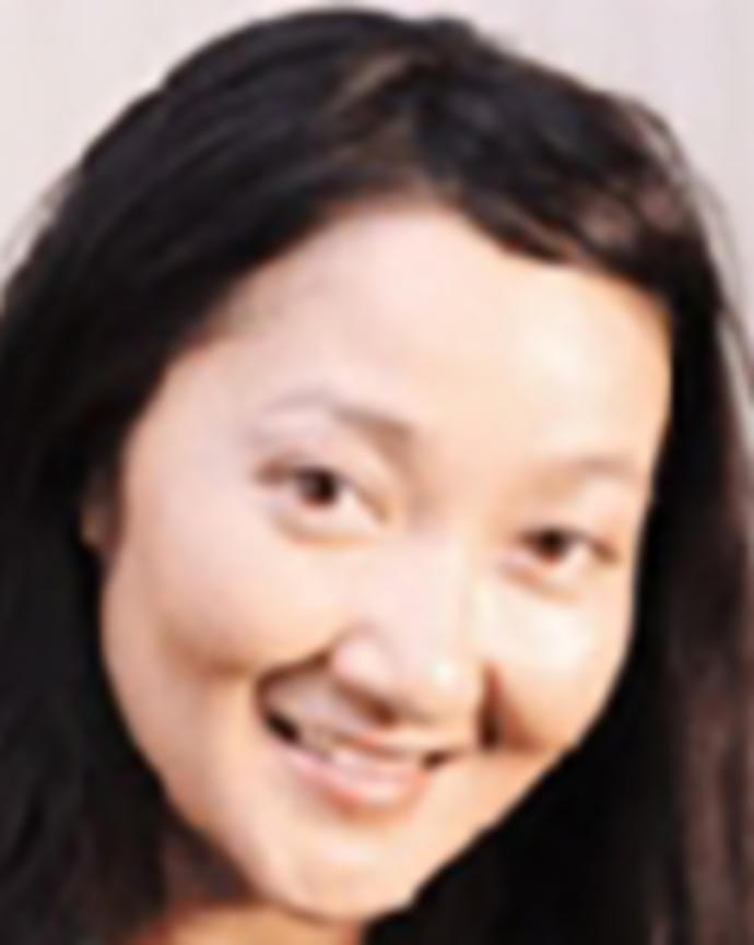 Monica Le has long straight black hair and is wearing a green shirt.