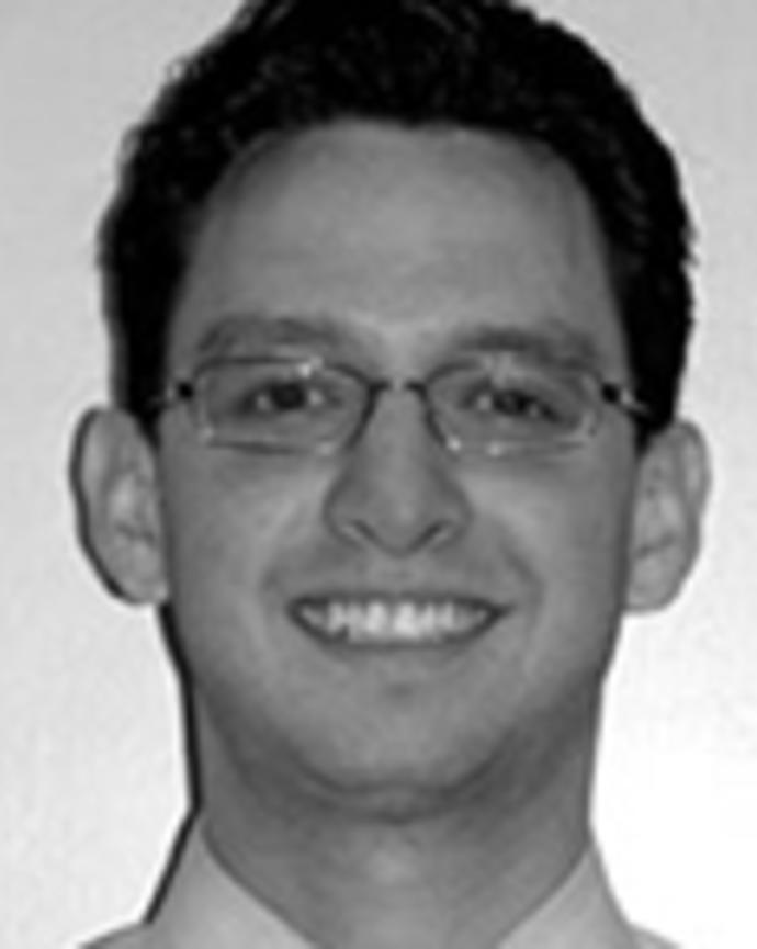 Christian Arbelaesz has short dark hair and glasses.