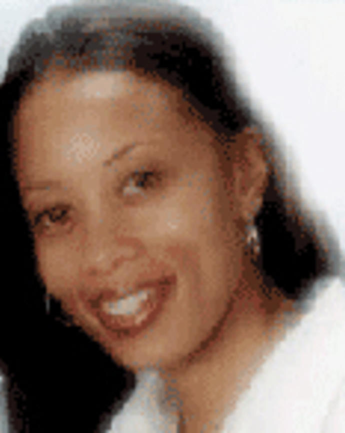 Stephanie Hale has long straight black hair. She is wearing a white shirt.