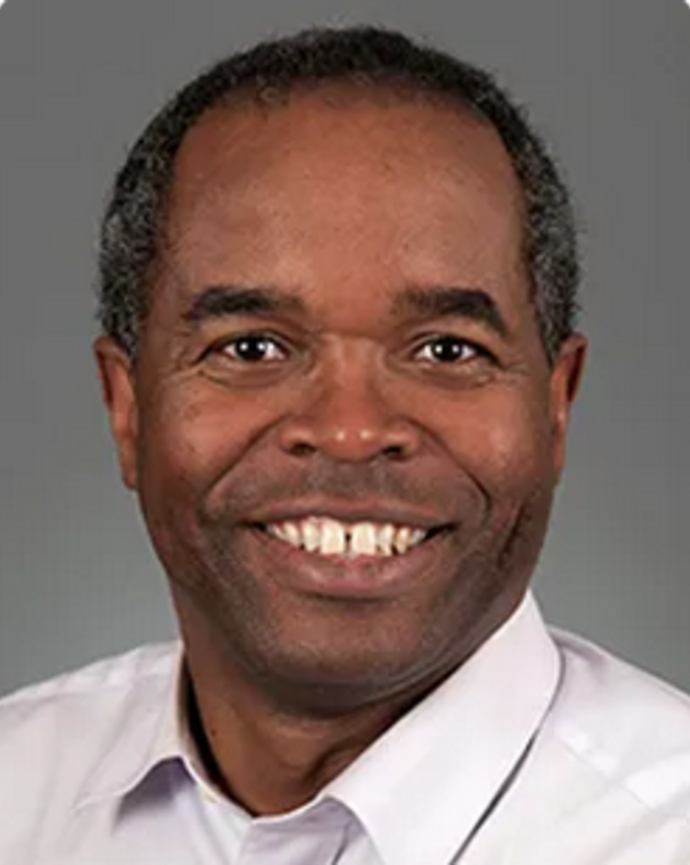 Luc Joseph has short gray and black hair.